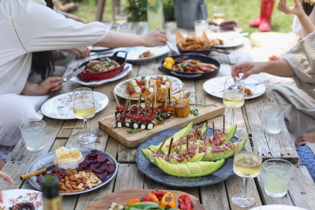 Family enjoying an abundant meal of food and wine outside